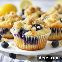 Lemon Blueberry Muffins with a crumb topping, golden brown and fluffy.