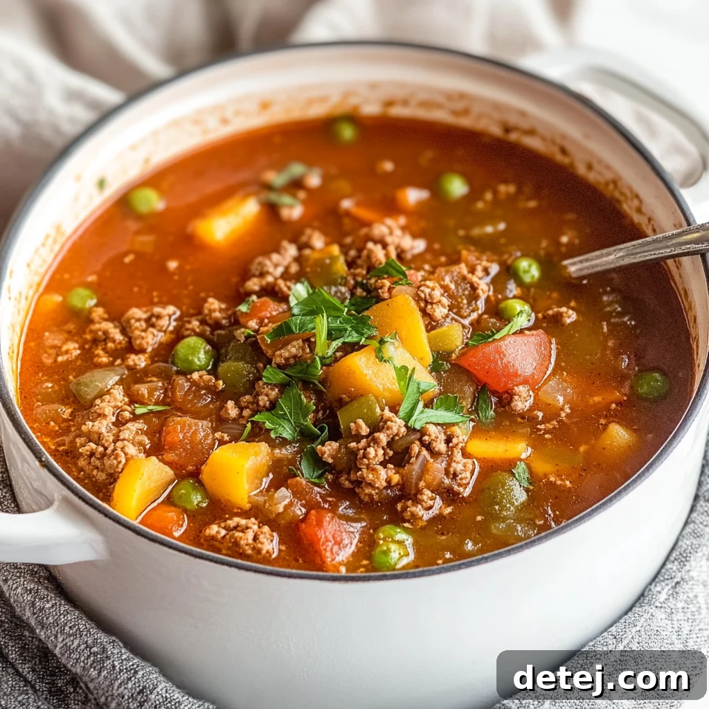 Hearty bowl of hamburger vegetable soup with crusty bread