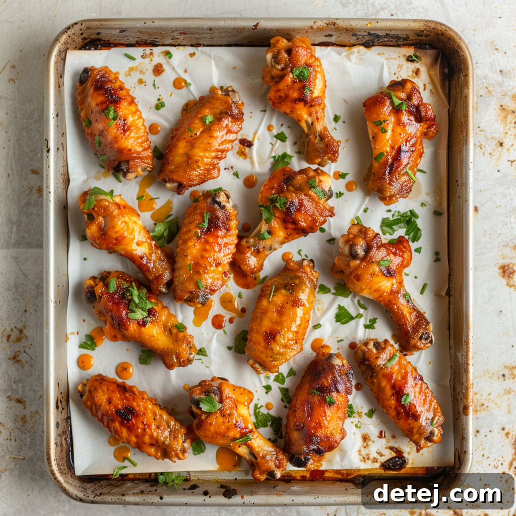 Dynamite Chicken Wings 3 Crispy Bang Bang Chicken Wings in an air fryer basket and on a baking sheet, showcasing different cooking methods.