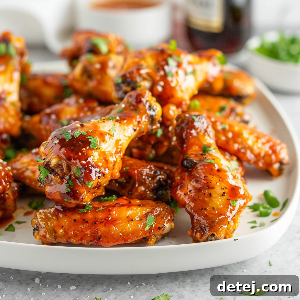 Dynamite Chicken Wings 4 Bang Bang Chicken Wings served with a side of rice and garnished with green onions and sesame seeds.