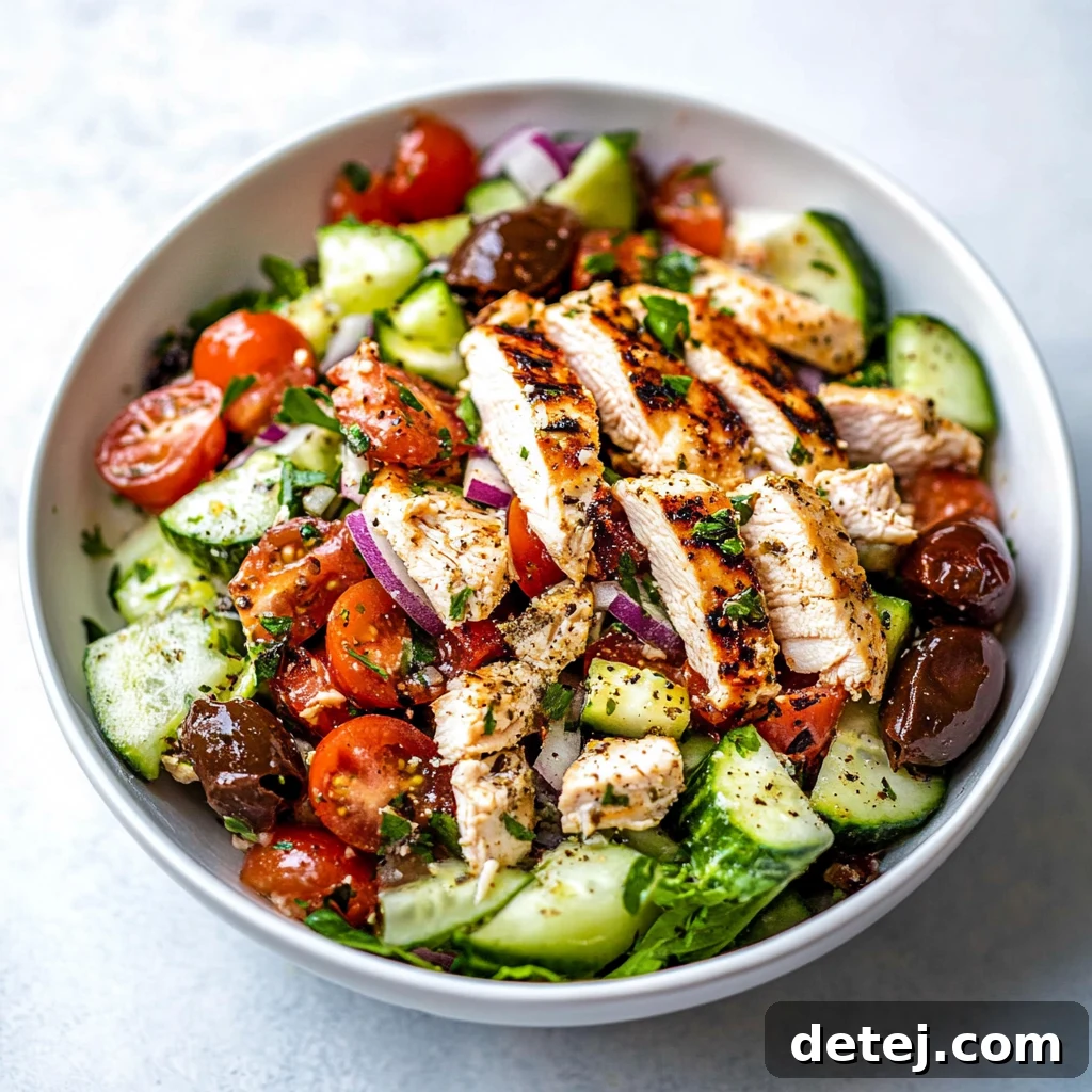 Greek Chicken Salad prepared in meal prep containers with dressing on the side