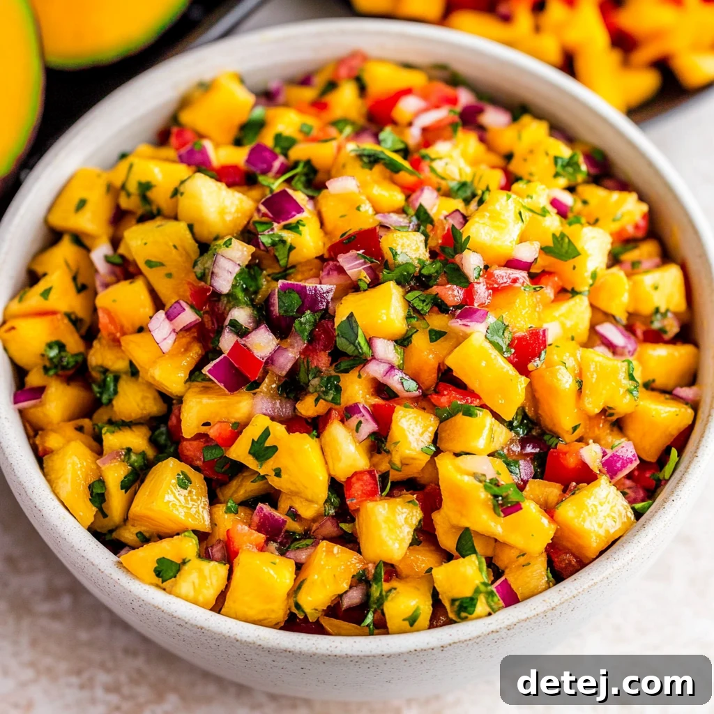 Sunshine Mango Salsa 2 Vibrant, freshly made mango salsa in a bowl with tortilla chips.