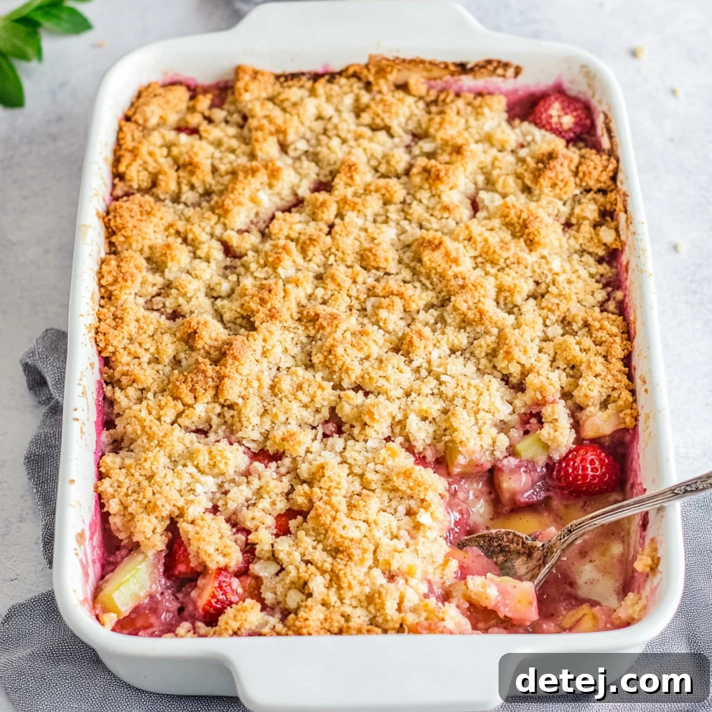 Delicious Rhubarb Strawberry Crumble served with ice cream, a perfect summer dessert.