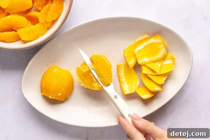 slicing orange segments. 