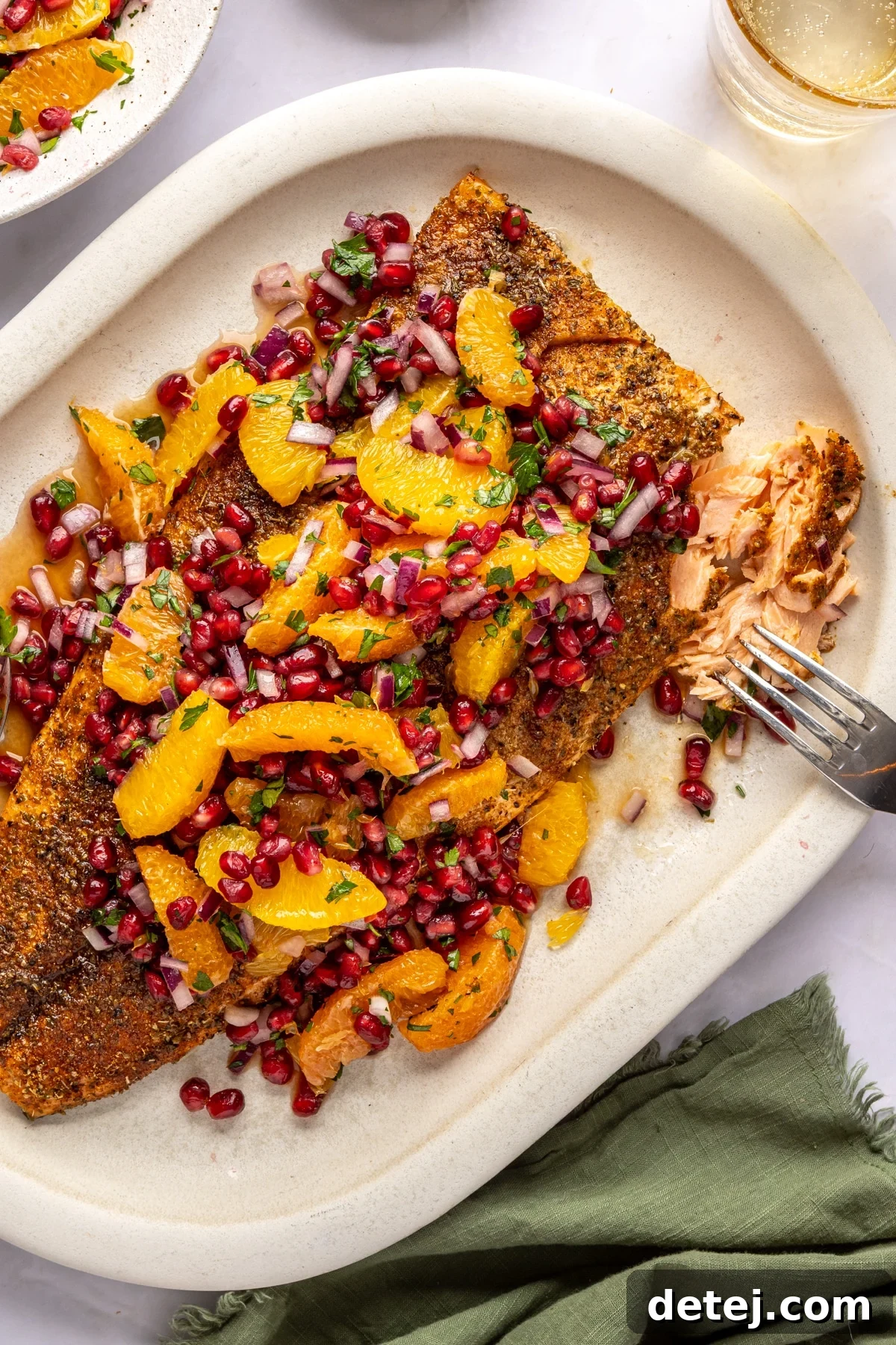 cooked salmon on a platter with citrus salad. 