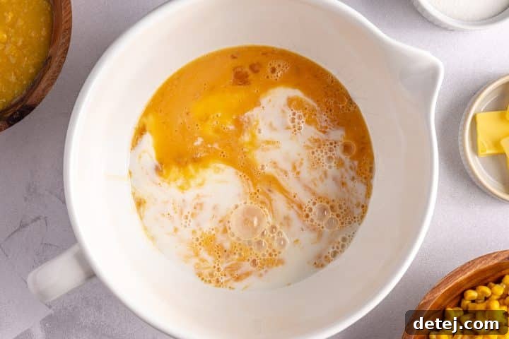 milk egg and sugar in a bowl.