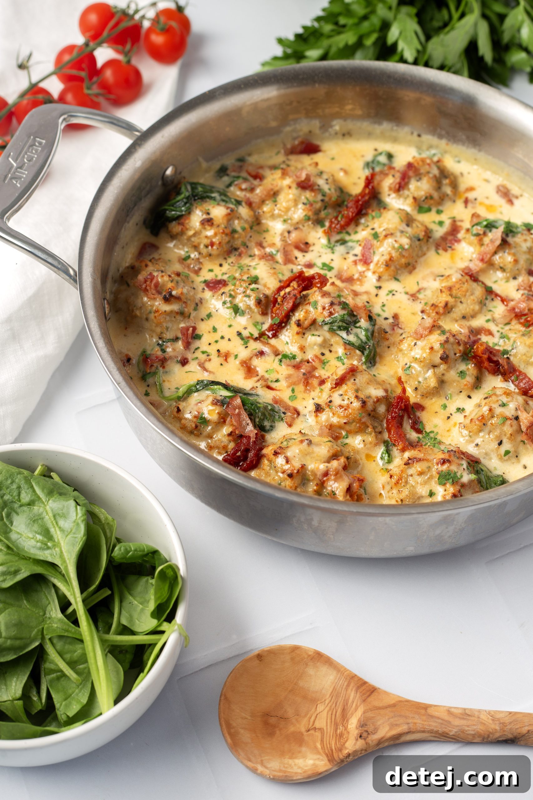 Finished creamy Tuscan chicken meatballs dish in a skillet, ready to be served