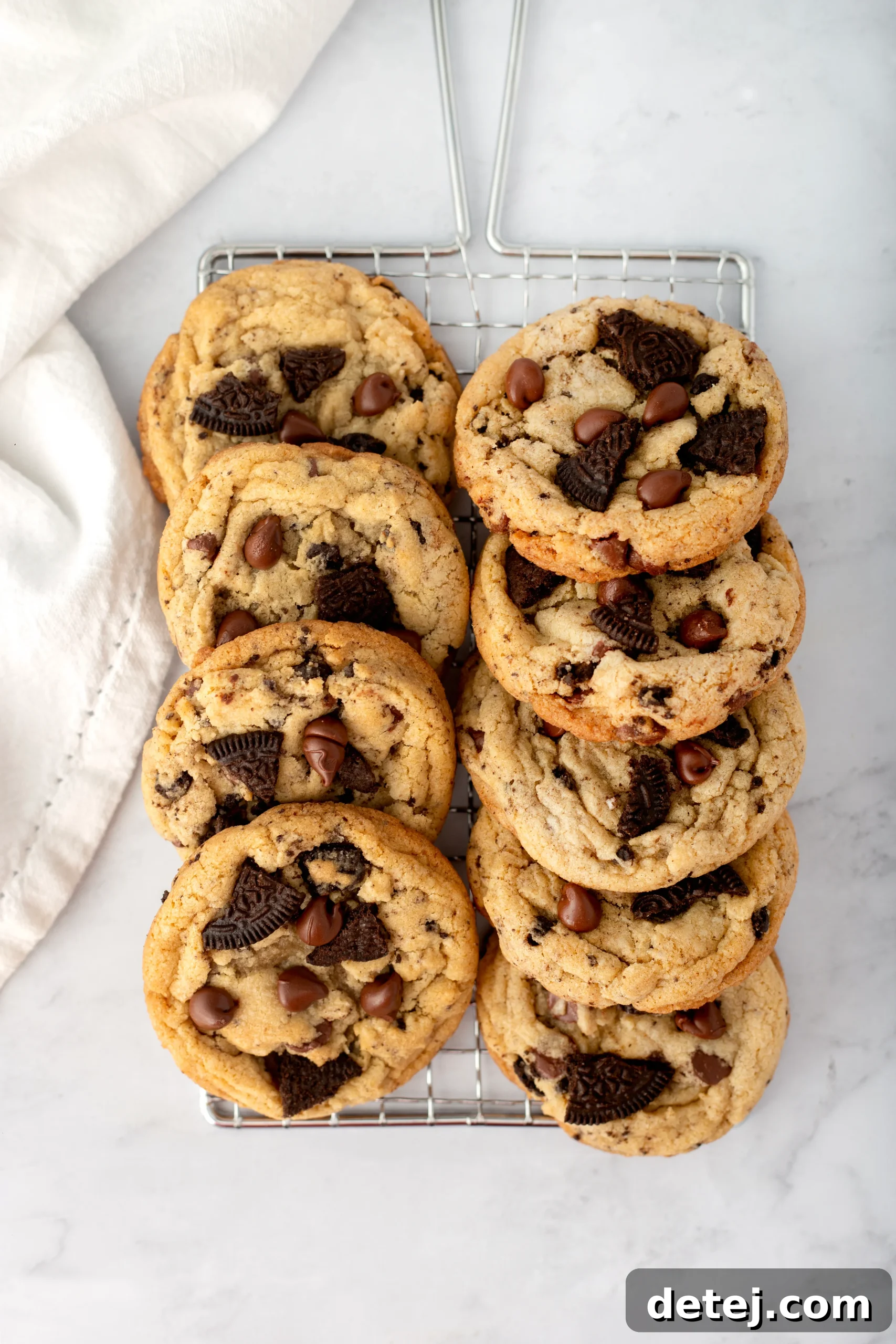 Decadent Bakery-Style Oreo Chocolate Chip Cookies, featuring a close-up of a stack of freshly baked cookies with visible chocolate chips and Oreo chunks.