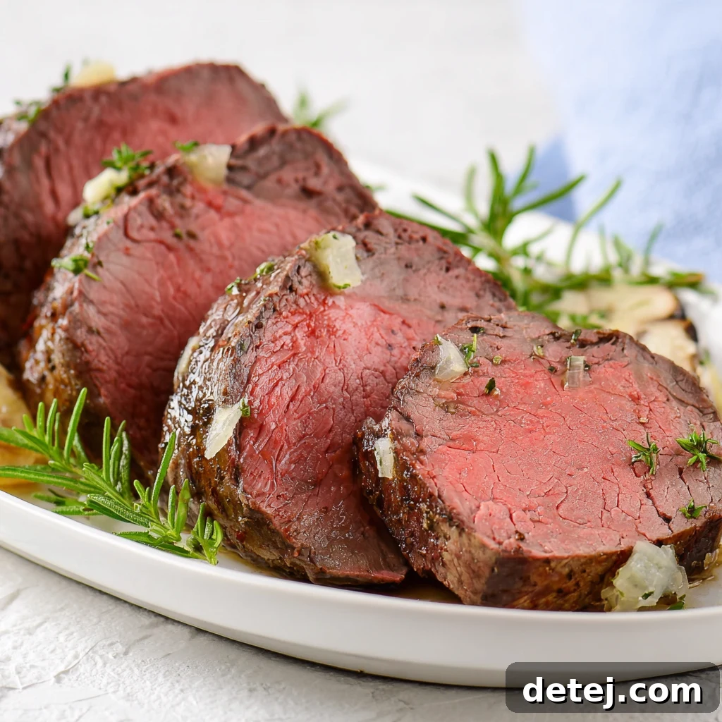 Easy Roasted Beef Tenderloin, sliced and ready to serve with side dishes