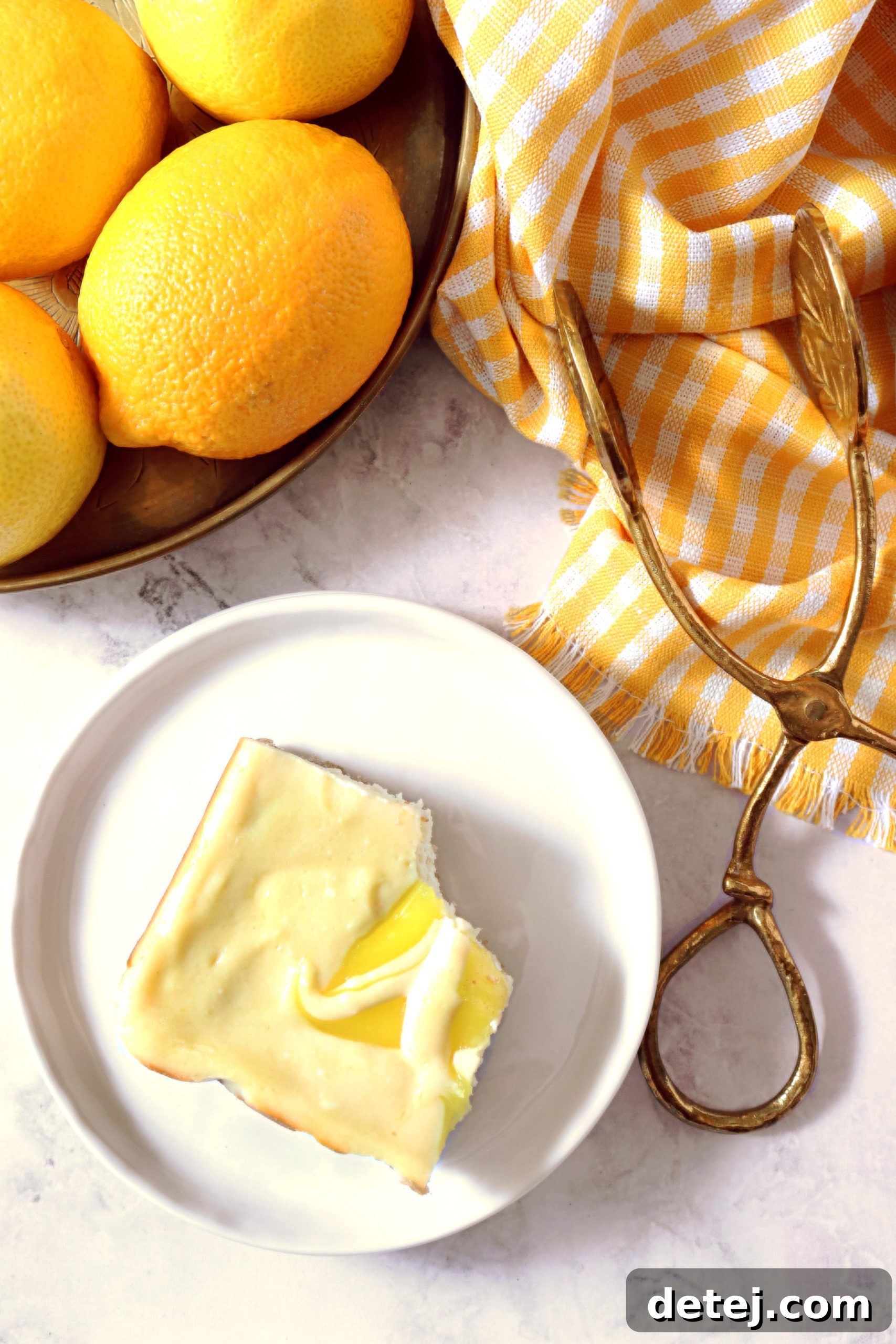 A close-up of a single Lemon Swirl Cheesecake Bar, perfectly sliced and ready to eat, with its distinct layers and lemon swirls visible.