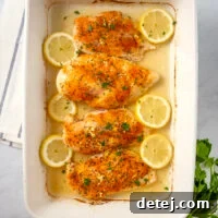 Baked Garlic Lemon Pepper Chicken with lemon slices.