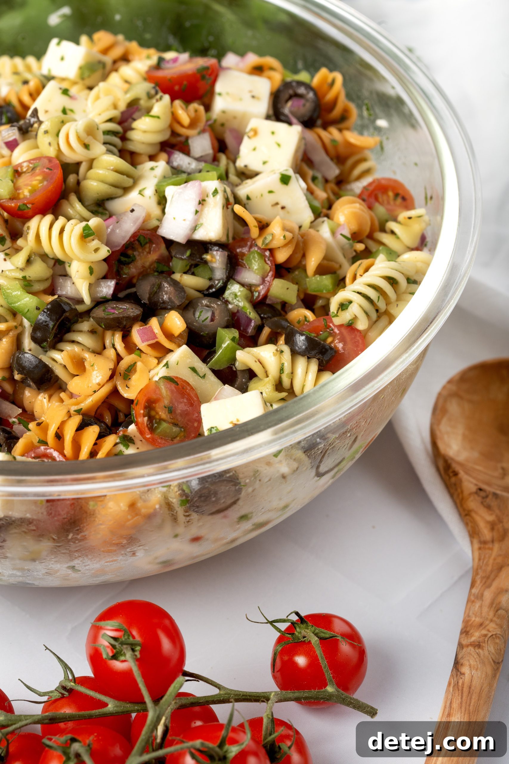 Vibrant Italian Pasta Salad 3 Close-up of uncooked tri-color rotini pasta, ideal for pasta salad.