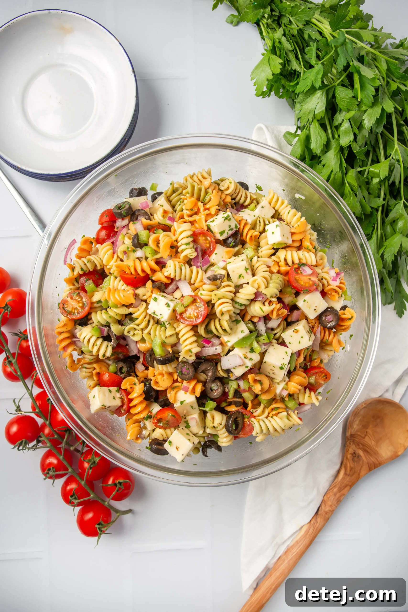 Vibrant Italian Pasta Salad 4 An array of fresh Italian pasta salad ingredients, including tomatoes, olives, and bell peppers.