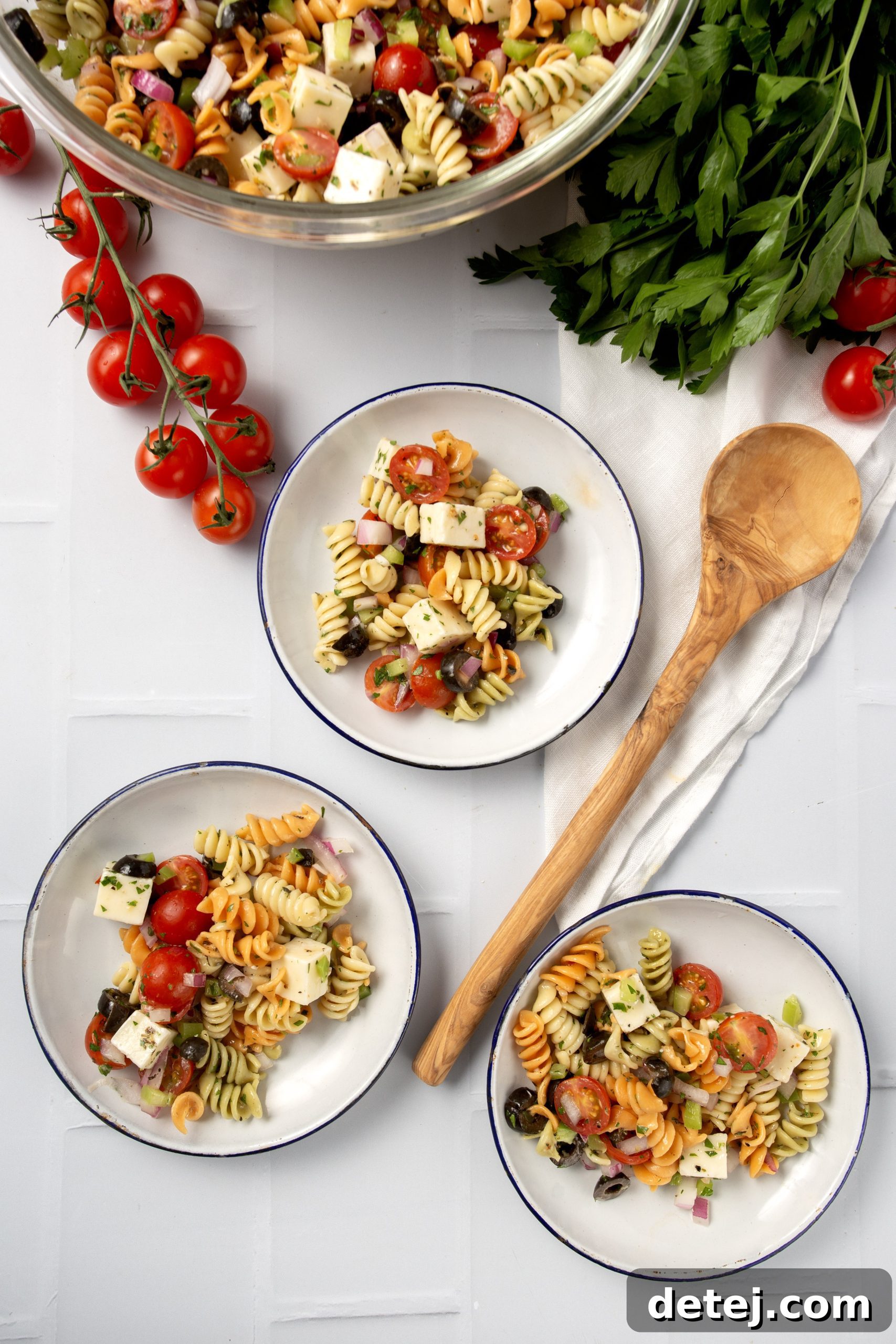 Vibrant Italian Pasta Salad 7 A person enjoying a forkful of vibrant Italian pasta salad outdoors.