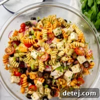 Vibrant Italian Pasta Salad 8 Close-up of a serving of Italian pasta salad in a white bowl.