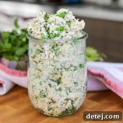 Creamy Chicken Salad with Spring Peas and Swiss Cheese in a jar, ready to be enjoyed.