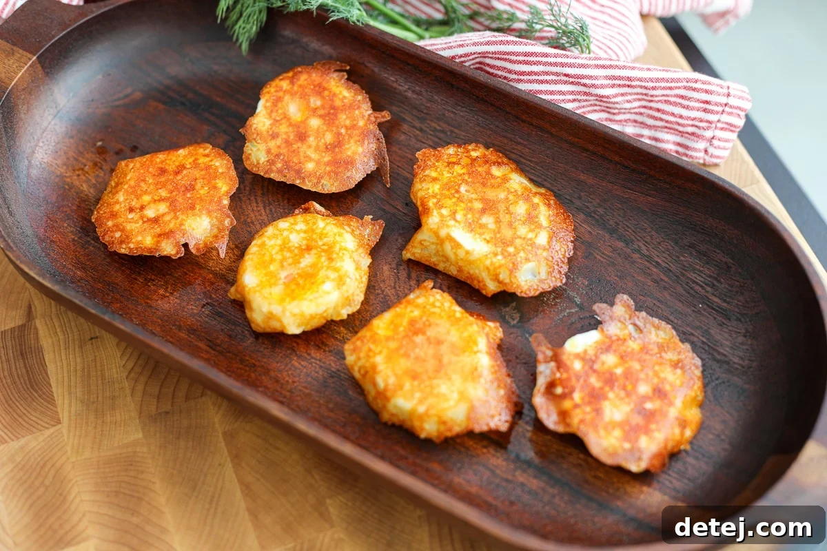 Close-up of crispy cheese egg bites on a white plate, showcasing the texture.