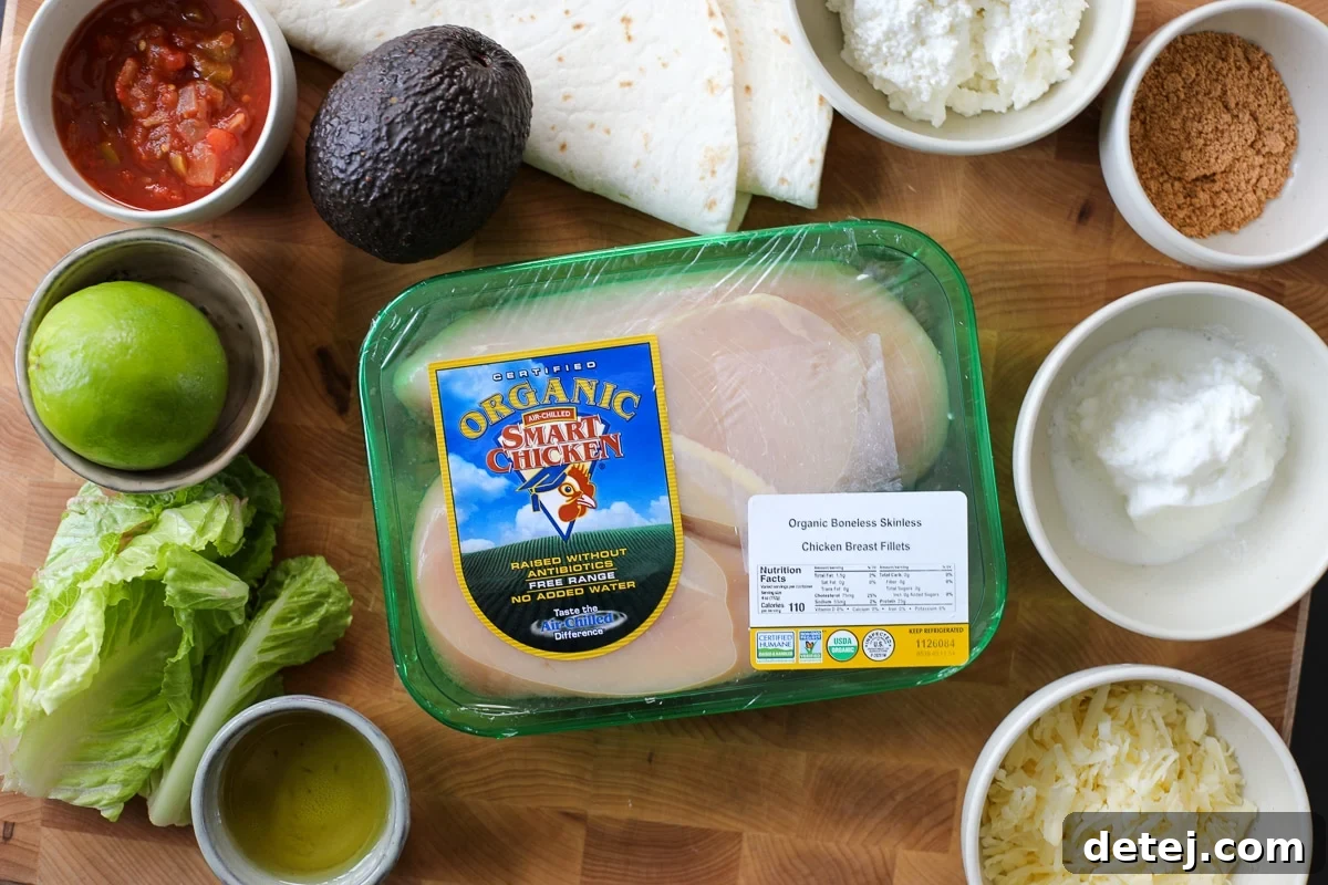 Fresh ingredients laid out for preparing chicken power wraps, including Smart Chicken breasts, avocado, lettuce, and spices.