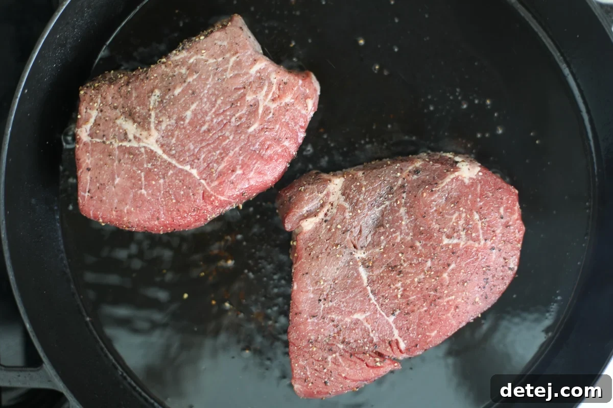 Seared Steak & Blueberry Harvest Salad 4 seasoned steak in a pan.