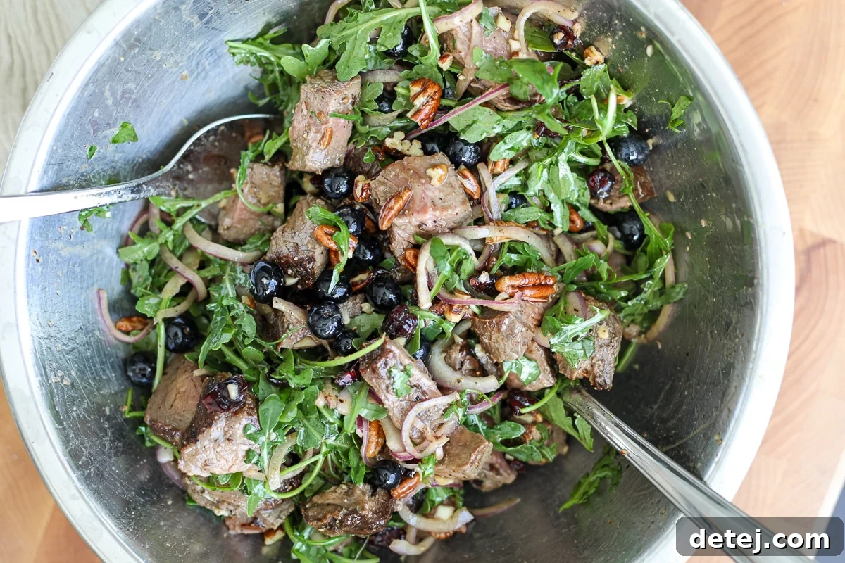 Seared Steak & Blueberry Harvest Salad 8 steak salad with blueberries and toppings.