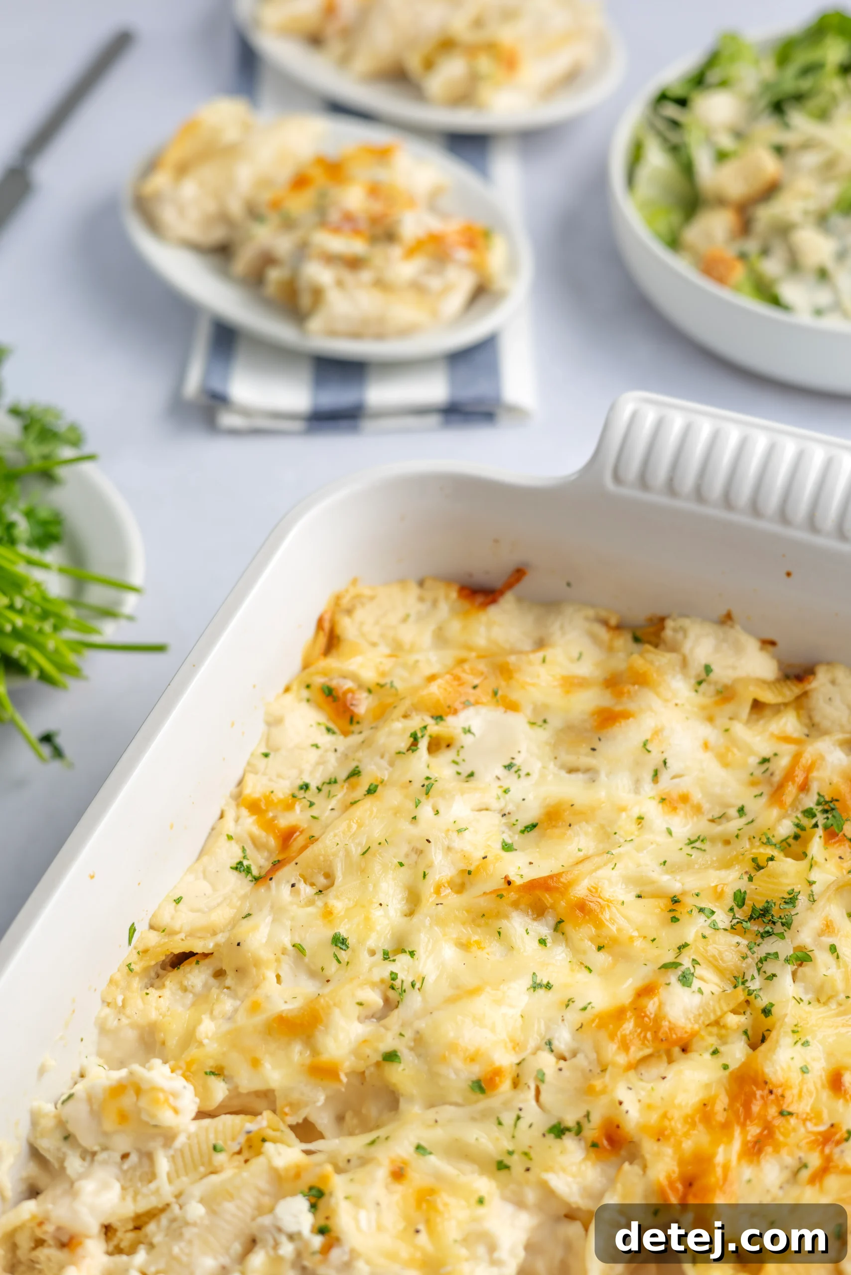 A dish of Cheesy Chicken Alfredo Stuffed Shells fresh out of the oven