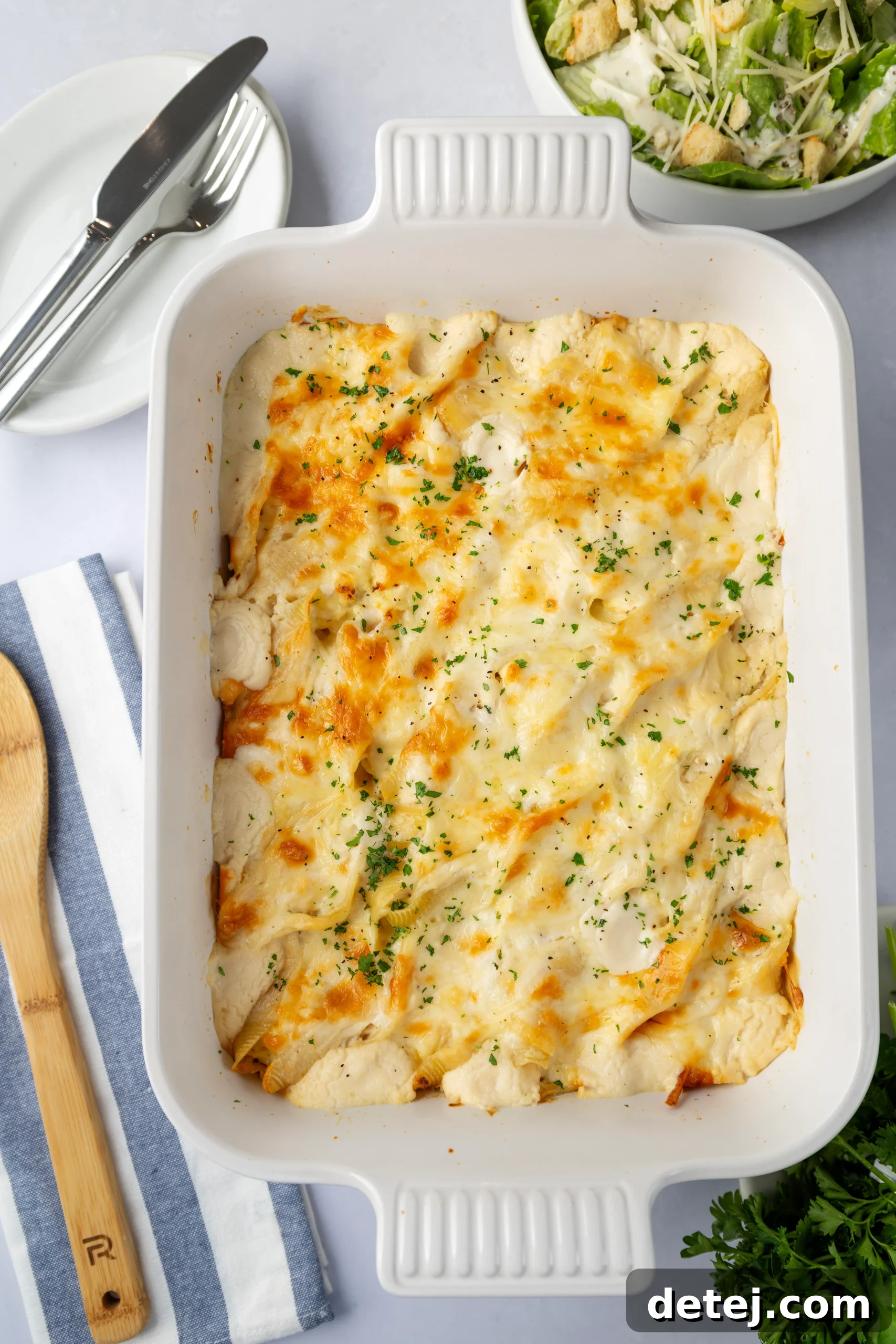 Step-by-step image of filling pasta shells with chicken and cheese mixture
