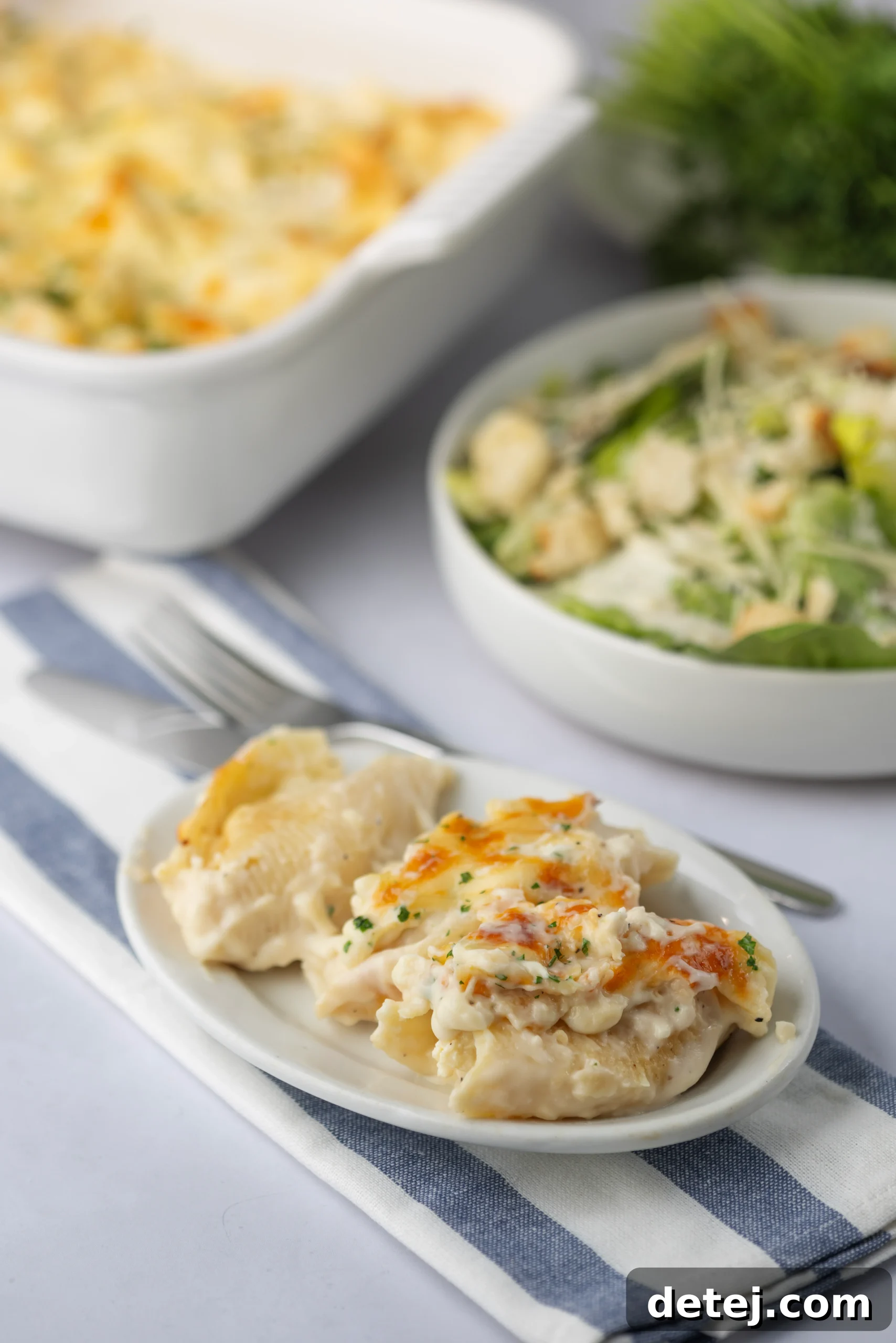 Serving of Cheesy Chicken Alfredo Stuffed Shells garnished with fresh parsley