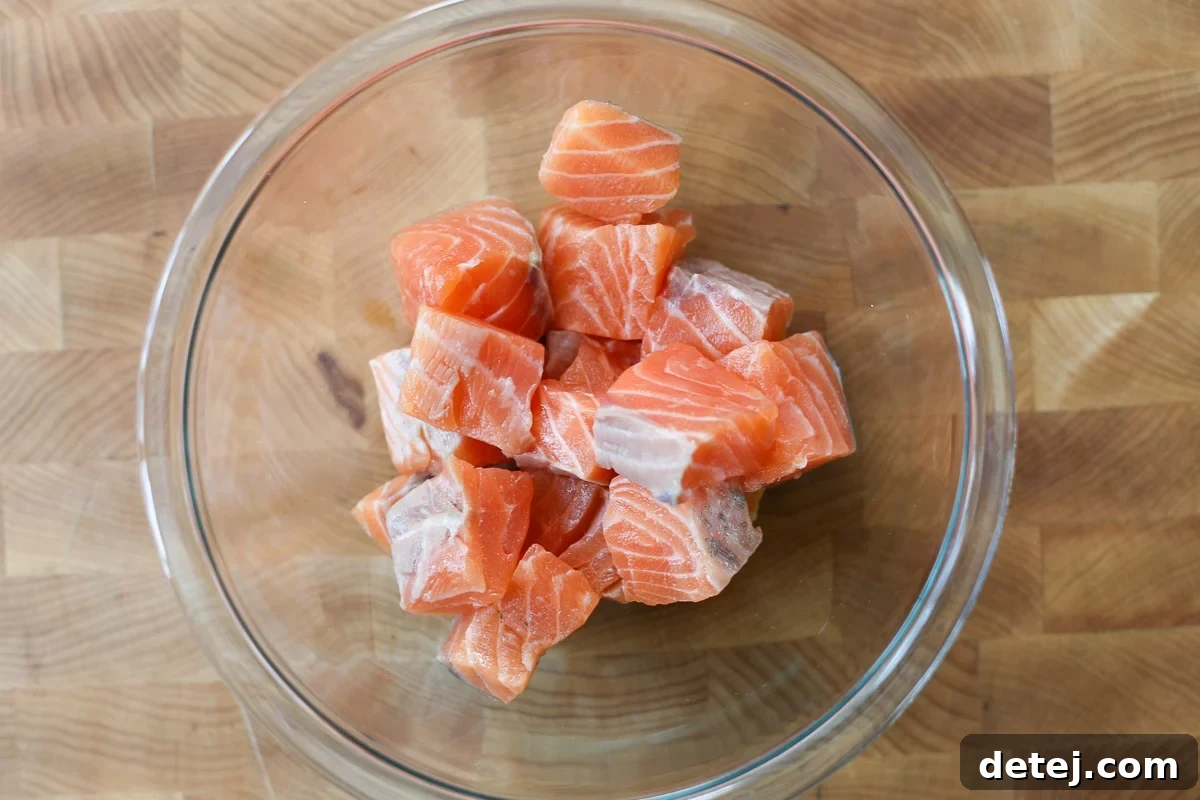 cubes salmon in a bowl.