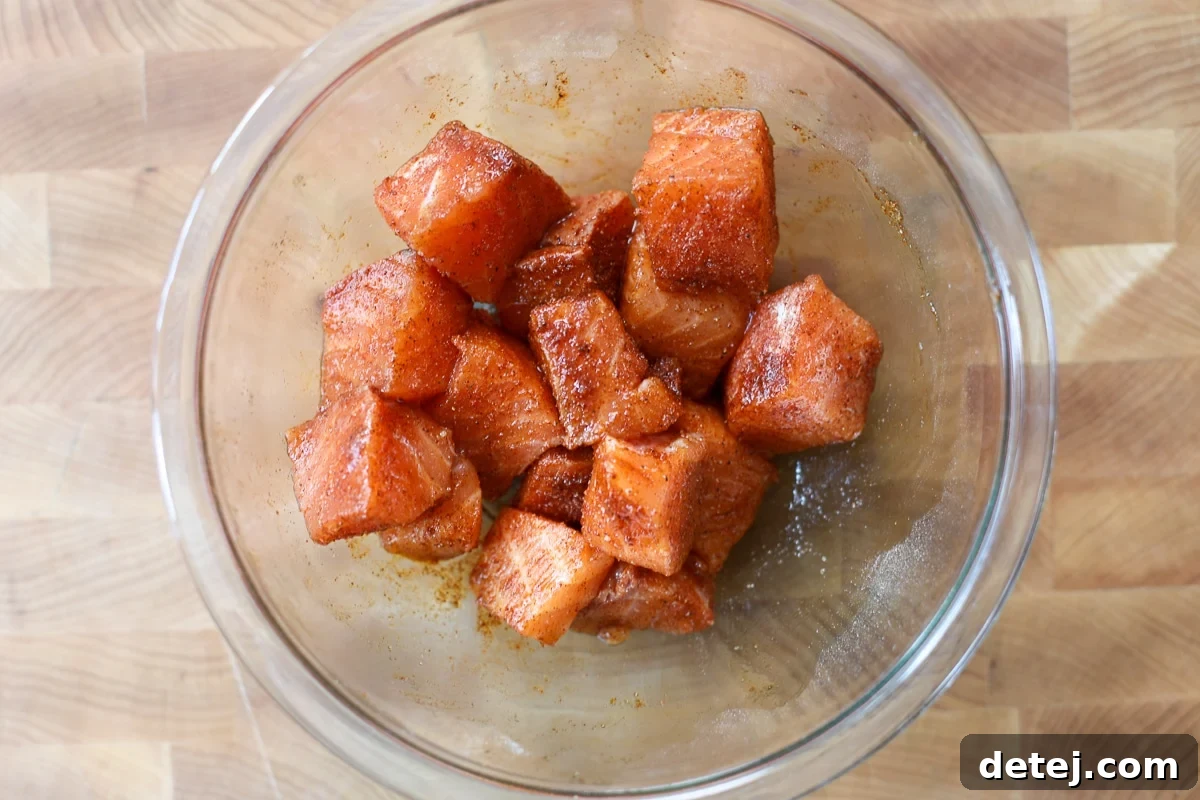 seasoned cubed salmon in a bowl.