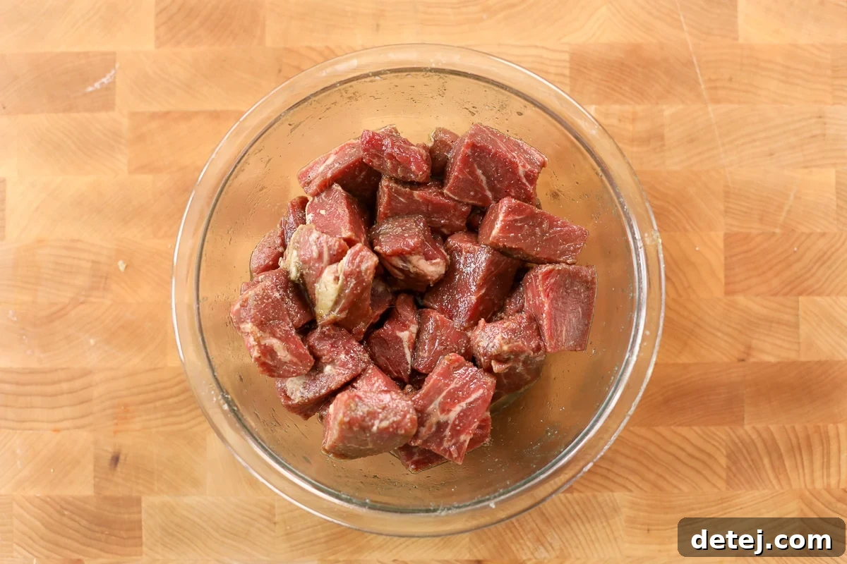 Mediterranean Steak Salad with Sun-Dried Tomato Vinaigrette 4 steak bites in a bowl marinating.