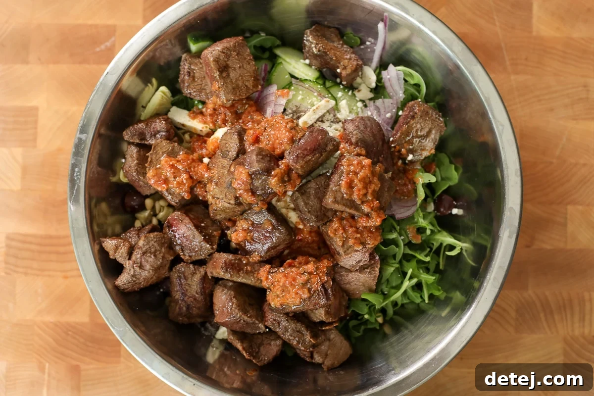 Mediterranean Steak Salad with Sun-Dried Tomato Vinaigrette 8 steak salad in a bowl.