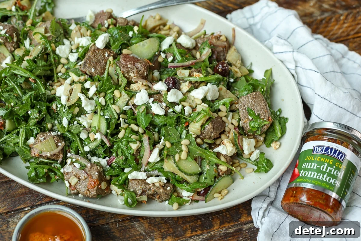 Mediterranean Steak Salad with Sun-Dried Tomato Vinaigrette 9 steak salad with delallo sun-dried tomatoes next to it.